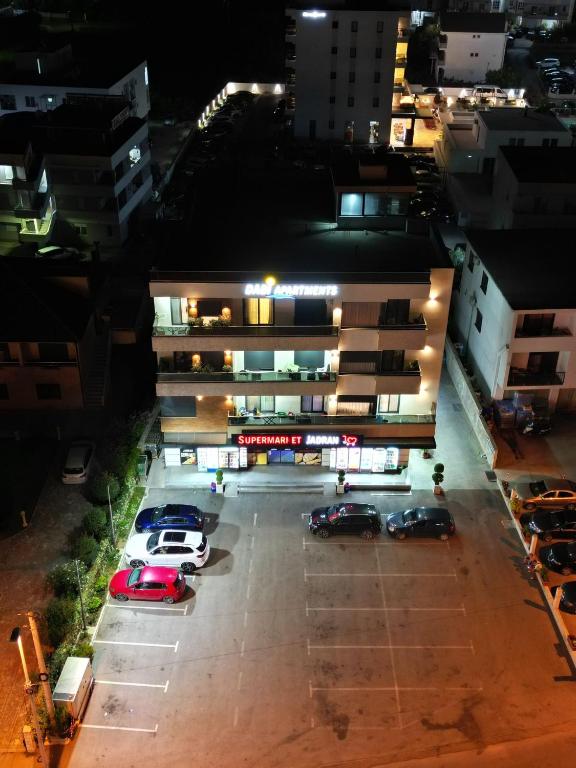 a parking lot with cars parked in front of a building at Apartments DABI in Ulcinj