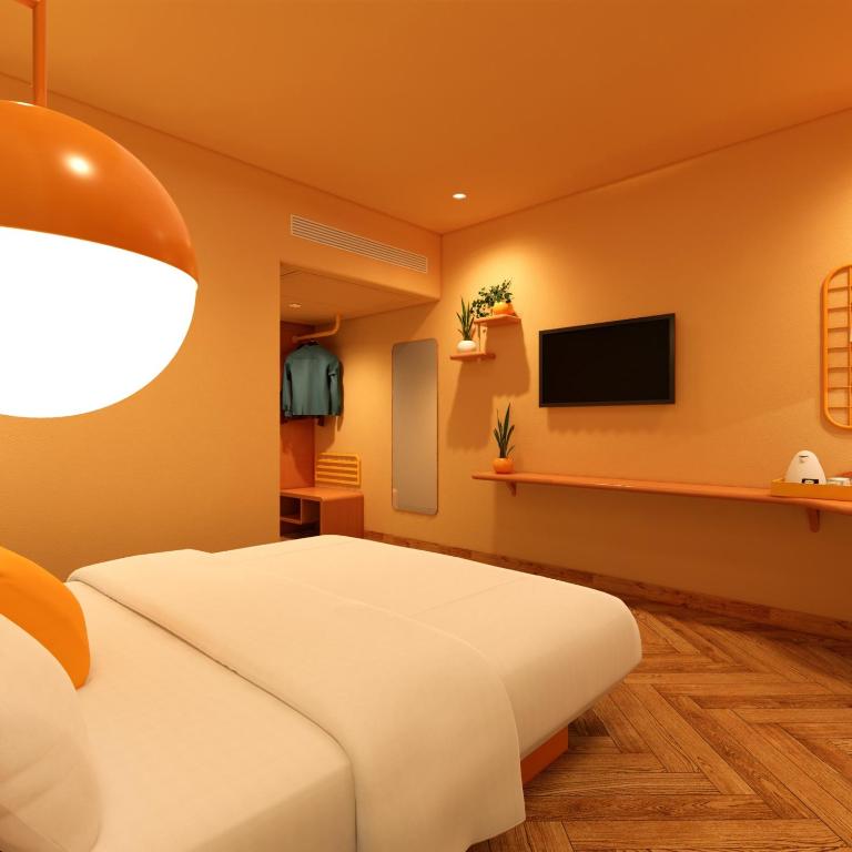 TV a/nebo společenská místnost v ubytování Bloom Hotel - Golf Course Road, Sector 43