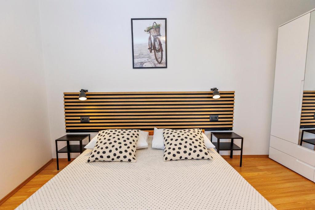 a bedroom with a large bed with two pillows at Apartments Baričević in Bol