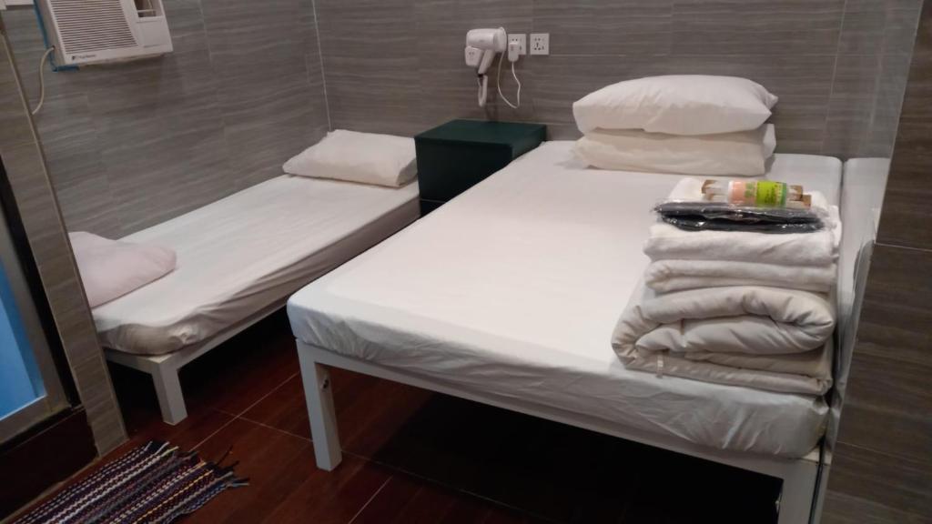 A bed or beds in a room at New Garden Hostel