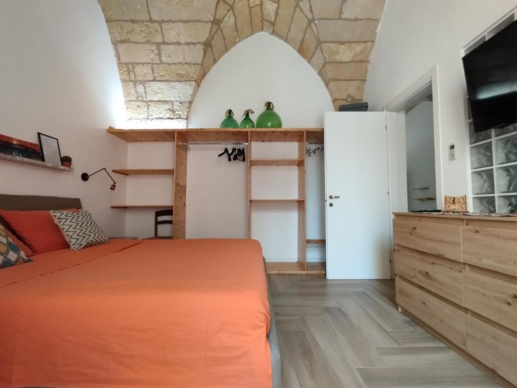 a bedroom with an orange bed in a room at La Casecchia in Porto Cesareo