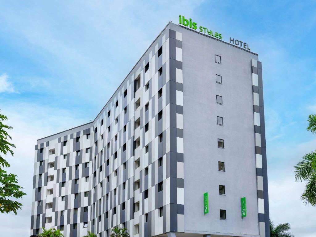 a building with a sign on the top of it at Ibis Styles Accra Airport in Accra