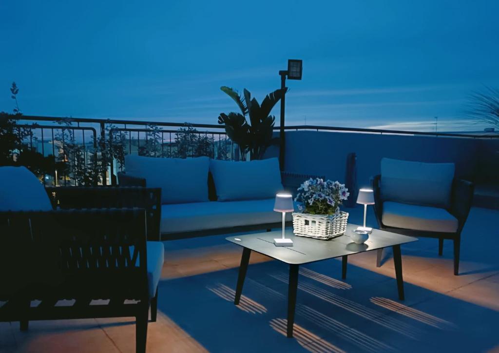 patio con sofá y mesa en el balcón en AtticoCinque, en Bari