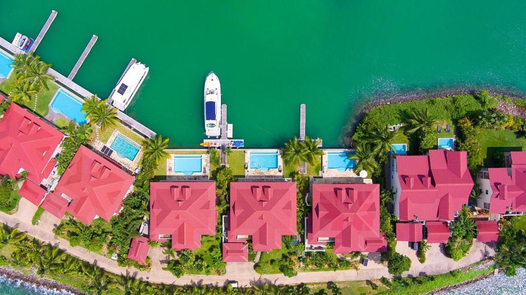 an aerial view of an island with pink buildings and the ocean at Eden Island Luxury Villa with Private Pool in Eden Island
