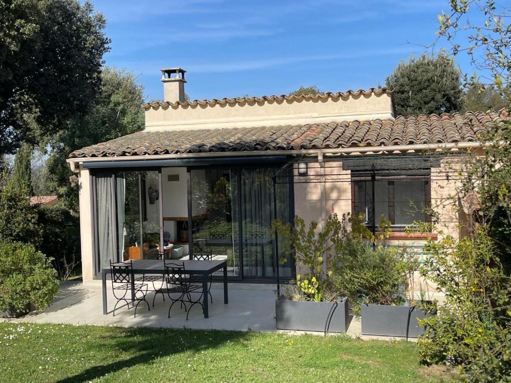 une maison avec une table et des chaises dans une cour dans l'établissement Résidence de charme à Grasse, à Grasse