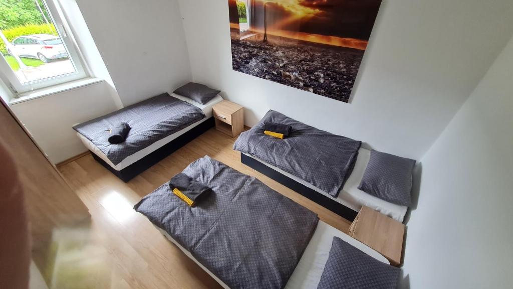 an overhead view of a room with two beds and a couch at Lesce Hostel in Lesce