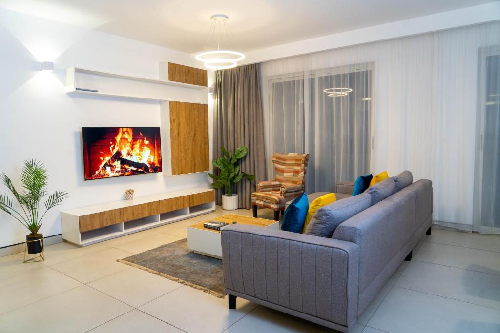 a living room with a couch and a fireplace at Purple Haze By AirCasa in Nairobi