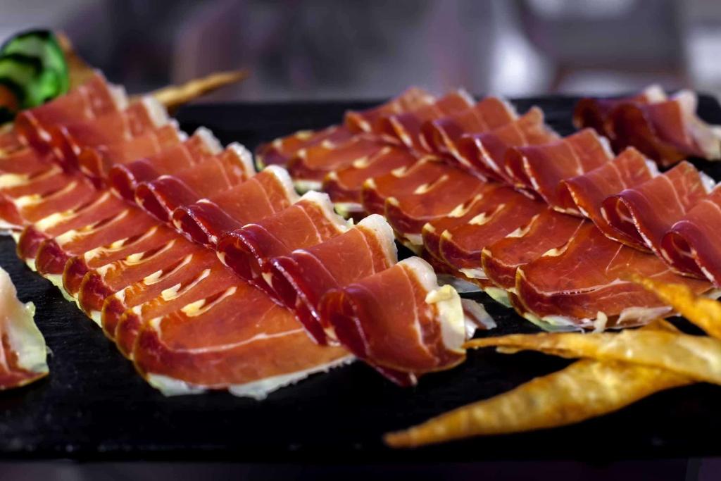 a row of bacon and french fries on a plate at Barceló Isla Canela in Isla Canela