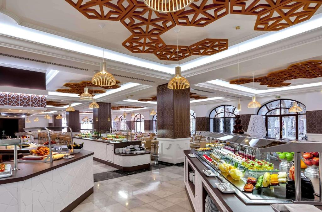 a restaurant with a lot of food on display at Barceló Isla Canela in Isla Canela