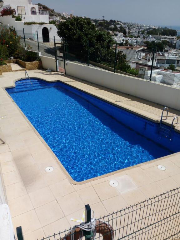 a swimming pool on the side of a building at Apto Calle España in Mojácar