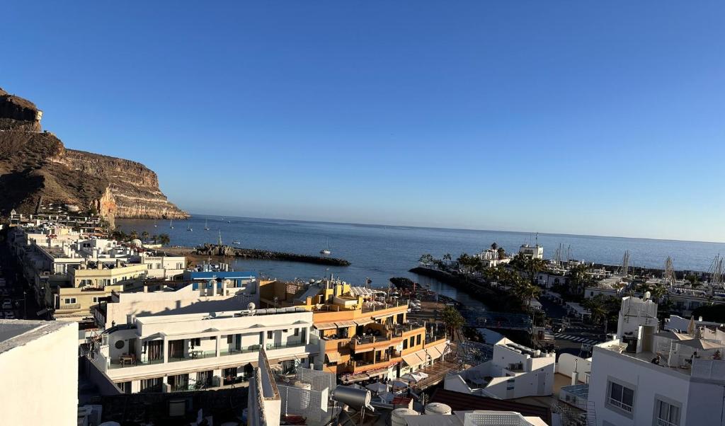 a view of a city with the ocean and buildings at Palm Leaf Mogan in Puerto de Mogán