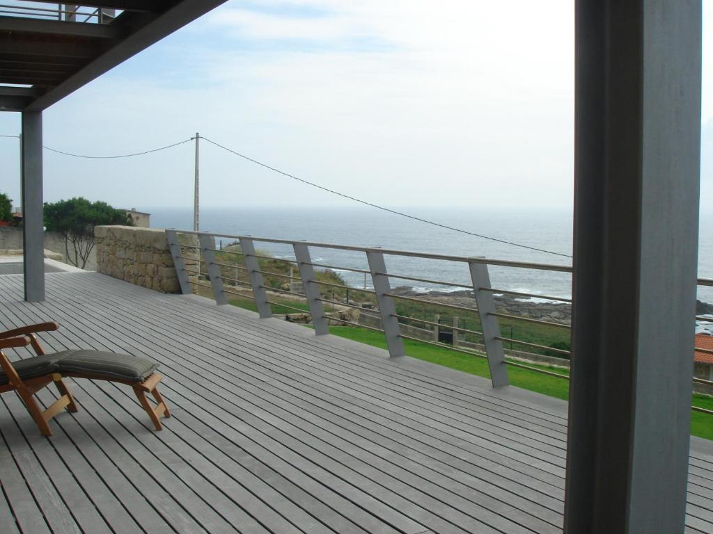 a balcony with a bench and a view of the ocean at Atlantic - Sea Front in Oia