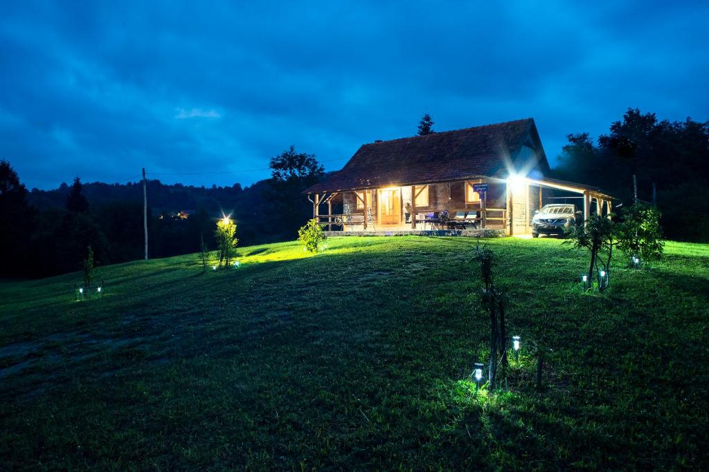 a house with a light on a field at night at Kuća za odmor Slunjčica in Slunj