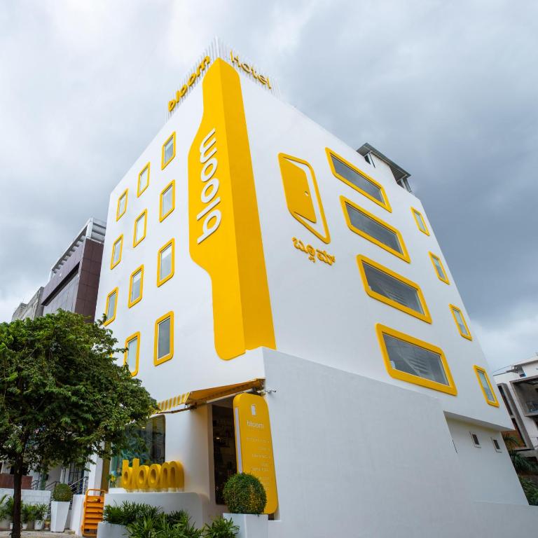 a building with a yellow sign on the side of it at Bloom Hotel - HSR Layout Sec 6 in Bengaluru