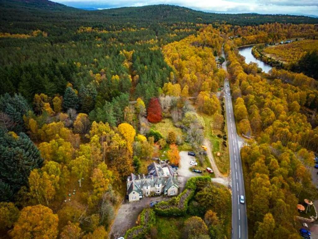 an aerial view of a house in the middle of a forest at Crannach House in Ballater