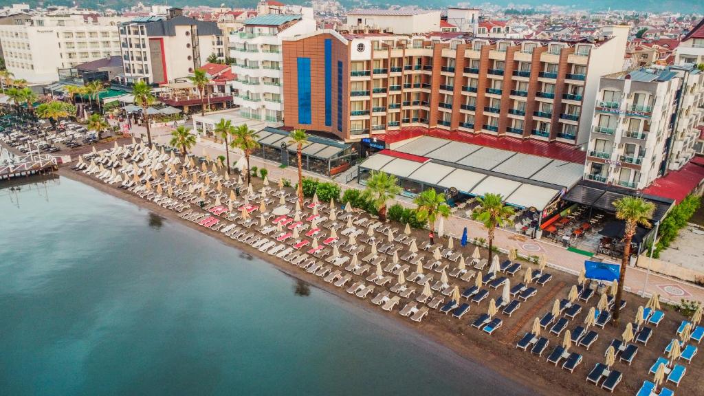 an aerial view of a beach with chairs and umbrellas at point beach hotel in Marmaris