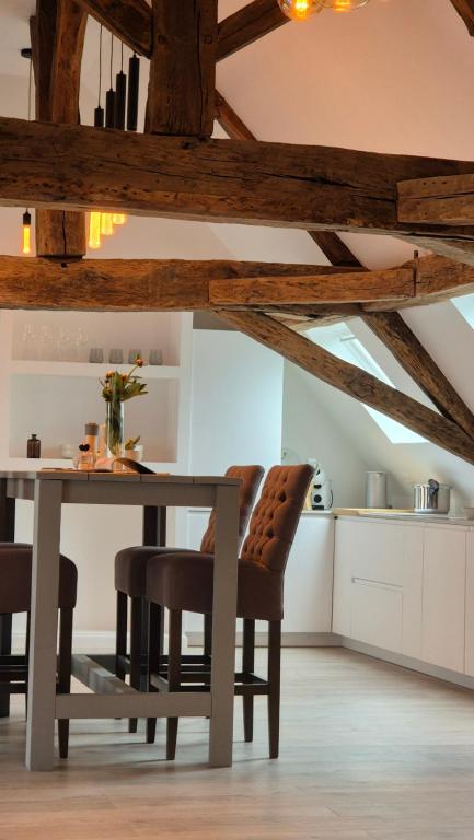a dining room with a table and some chairs at L'Arbre Voyageur - Suite de Luxe au cœur d'Autun in Autun