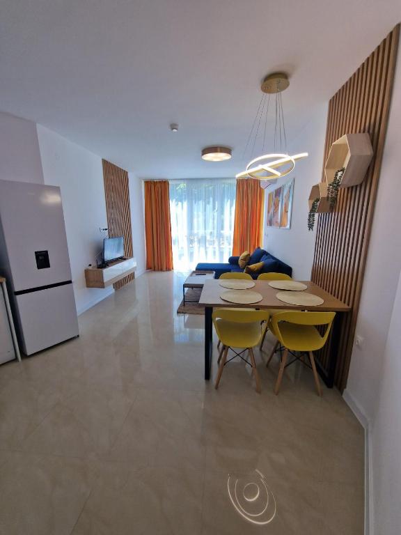 a kitchen and dining room with a table and chairs at Апартамент МеГи in Burgas