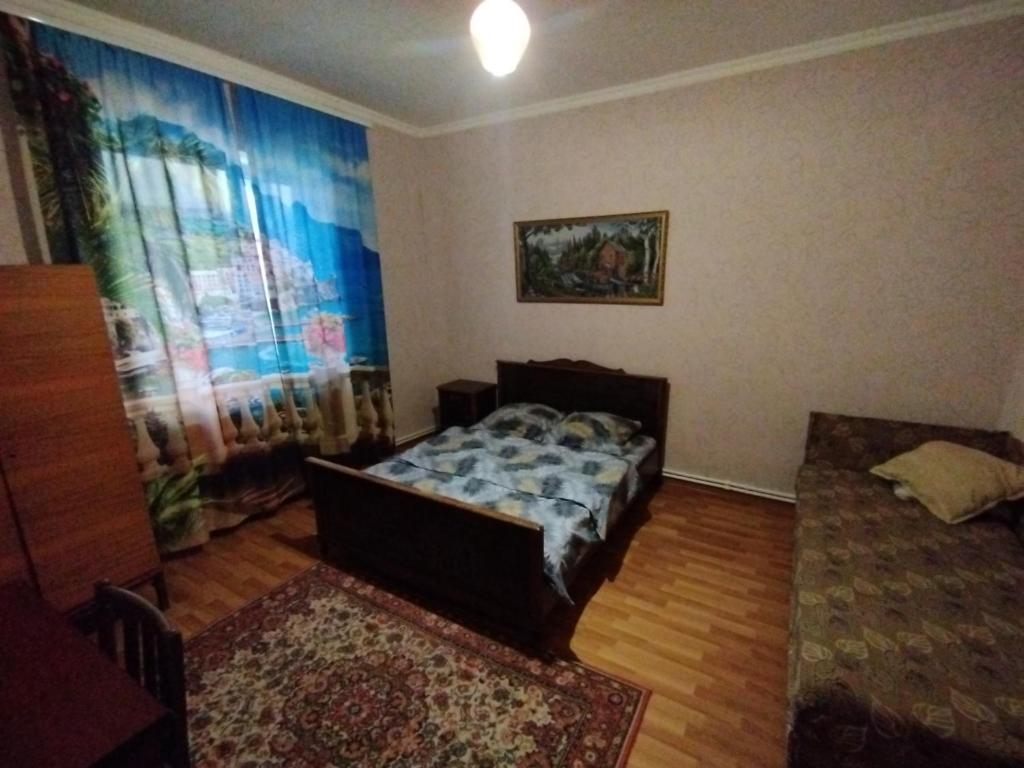 a living room with a bed and a window at Guest house Ed&Er in Geghanist