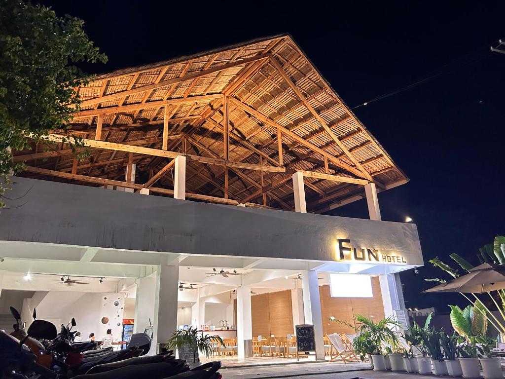a building with a wooden structure on top of it at Fun Hotel in Panglao