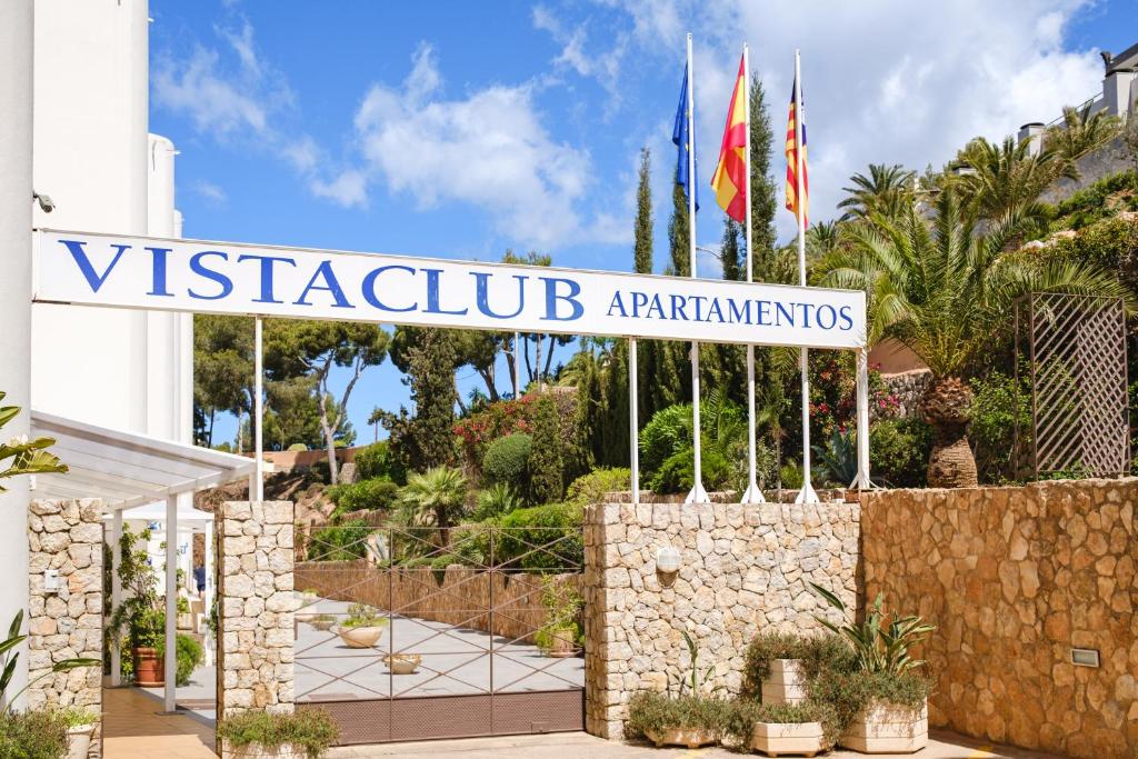 a sign for a villa in a resort with flags at Apartamentos Vista Club in Santa Ponsa