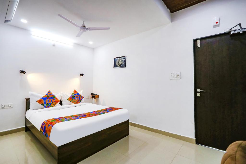 a bedroom with a bed and a door in it at FabHotel VK's in Hyderabad