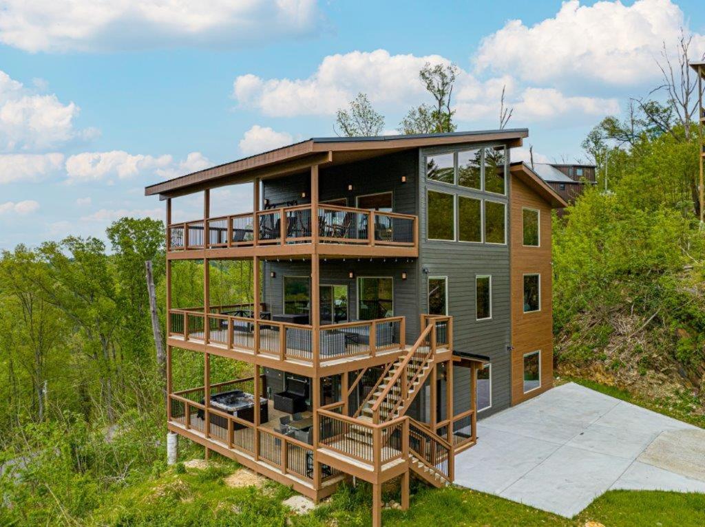 a house on a hill with a deck and stairs at Peace Giver by Eden Crest in Gatlinburg