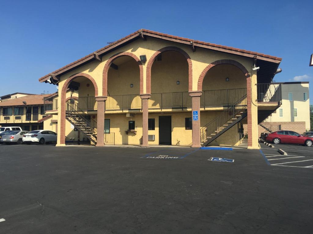 a building with a parking lot in front of it at Sierra Inn in South El Monte
