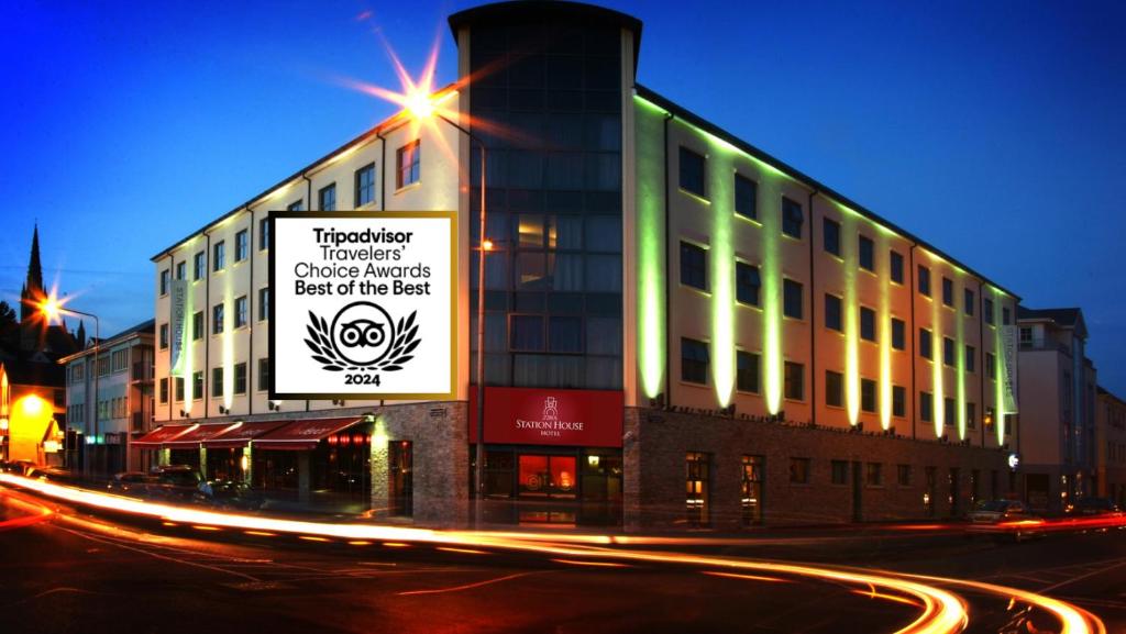 a building with a sign on the side of a street at Station House Hotel Letterkenny in Letterkenny
