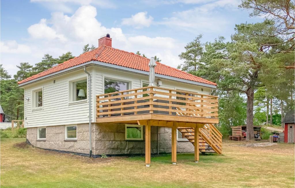 a house with a large deck on top of it at Nice Home In Vestery With Wifi in Rød