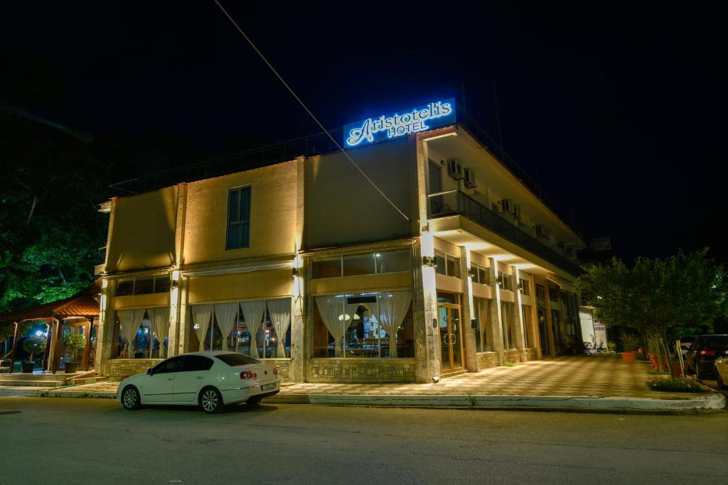 a building with a car parked in front of it at Aristotelis Hotel in Stavros