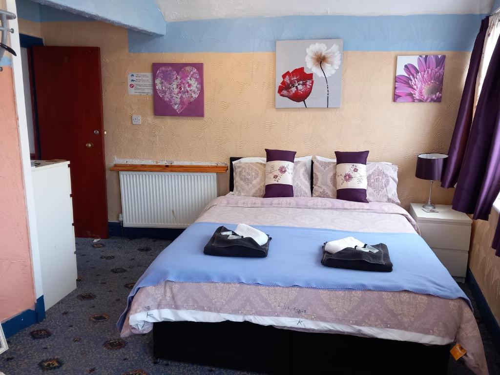 a bedroom with a bed with two towels on it at My Adam Hotel in Blackpool
