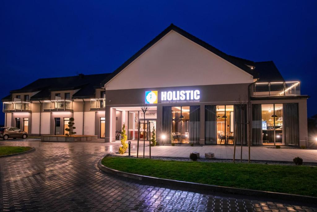 a building with a house at night at Holistic in Solec-Zdrój