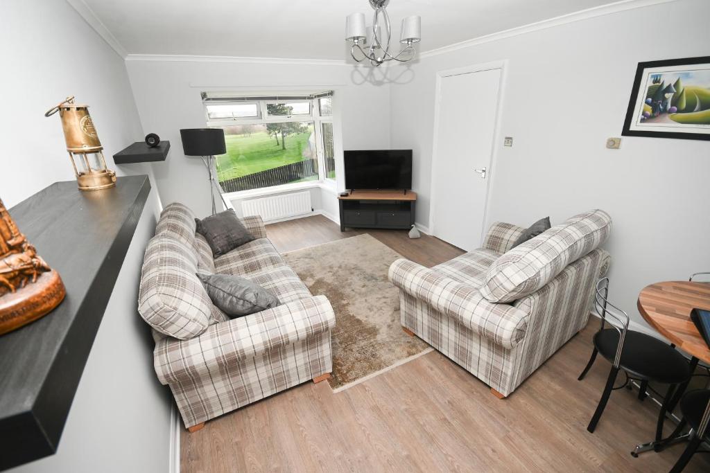 a living room with two couches and a television at 2 Bedroom Flat, Fabulous Views near Beamish Museum in Beamish