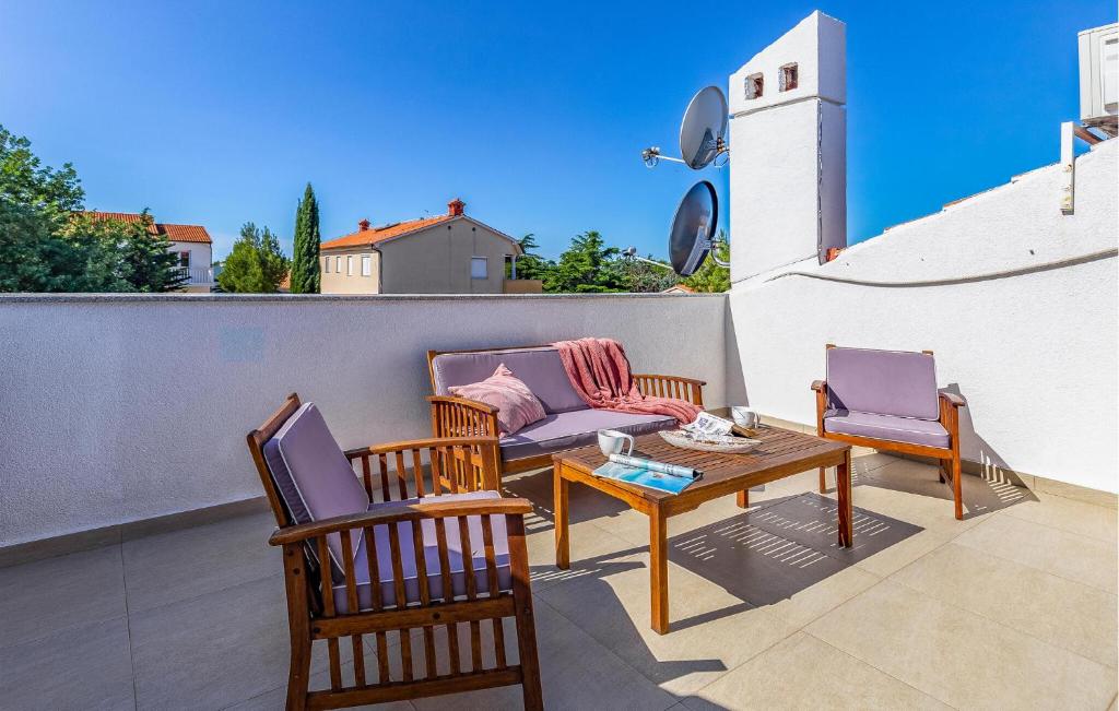 a patio with two chairs and a table and a couch at Apartment Fucane Iv in Medulin