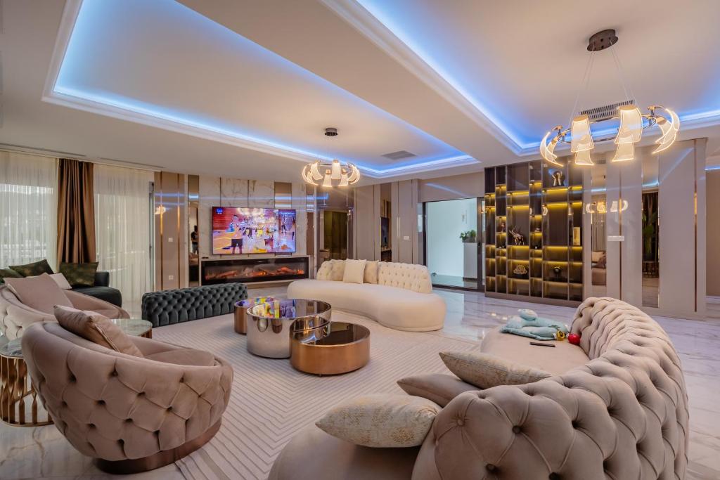 a large living room with a couch and chairs at Rafailovići Lux in Budva