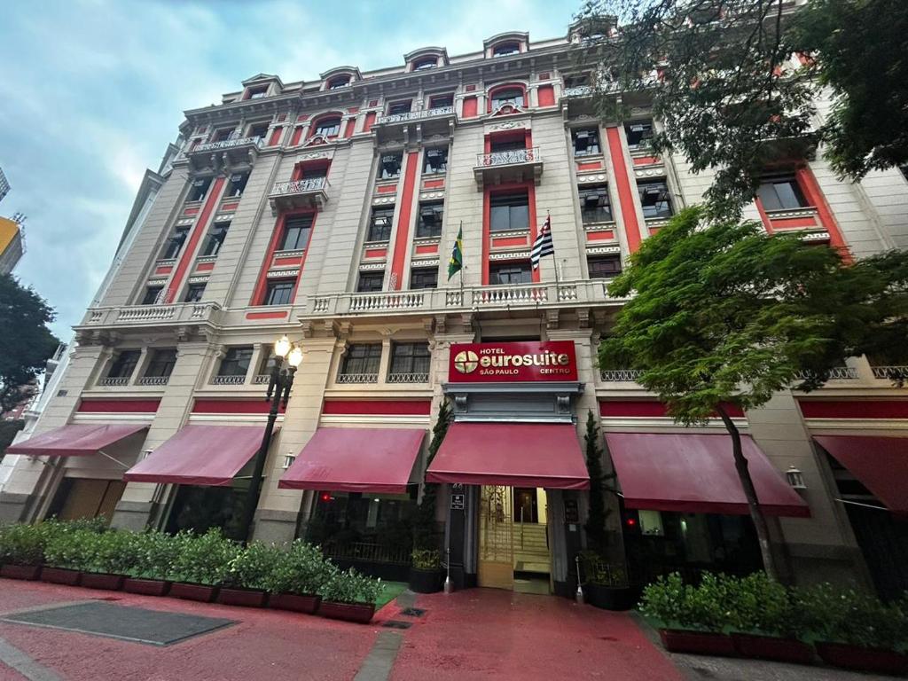 a large building with red awnings in front of it at Hotel Euro Suite São Paulo by Nacional Inn - A 600 METROS DA RUA 25 DE MARÇO in Sao Paulo