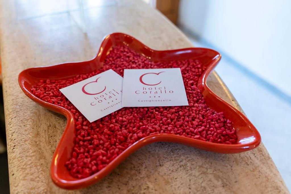 a red star shaped tray filled with red raspberries at Hotel Corallo in Castiglioncello