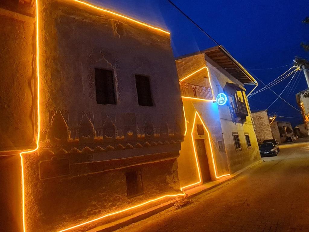 a building with lights on the side of it at night at KING SOLOMON PALACE in Avanos