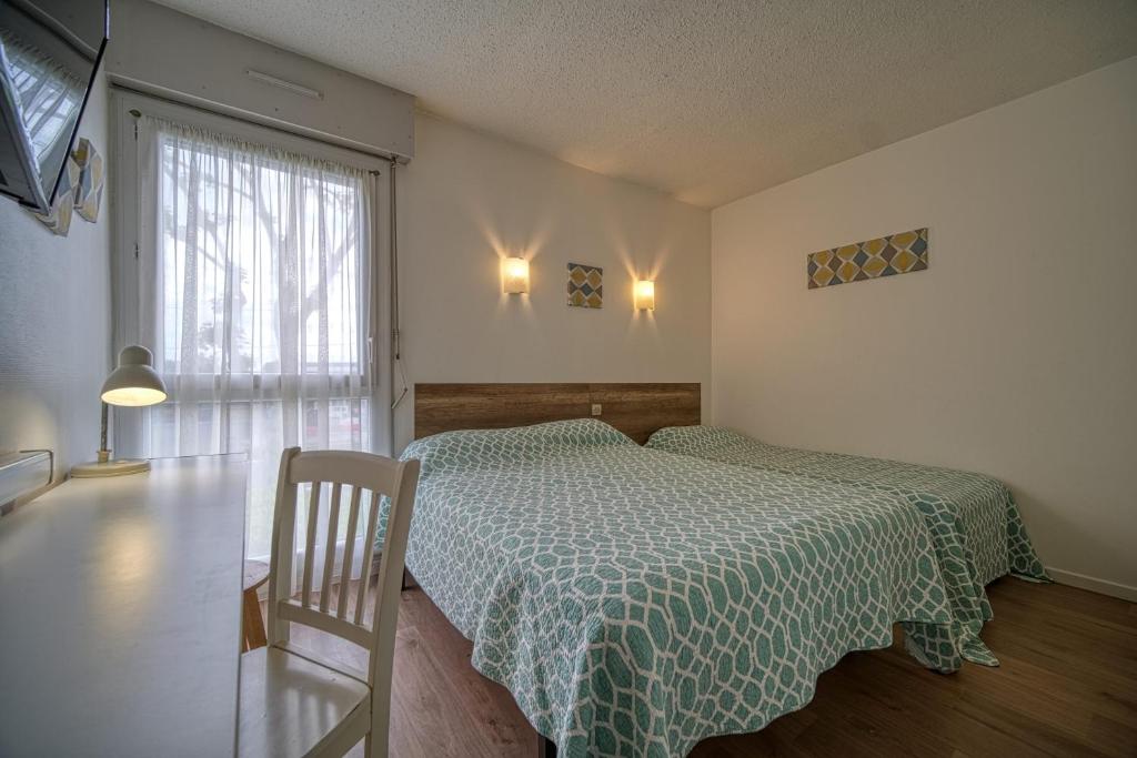 サン・ペレにあるHotel Coté Sudのベッドルーム1室(ベッド1台、緑の掛け布団、窓付)