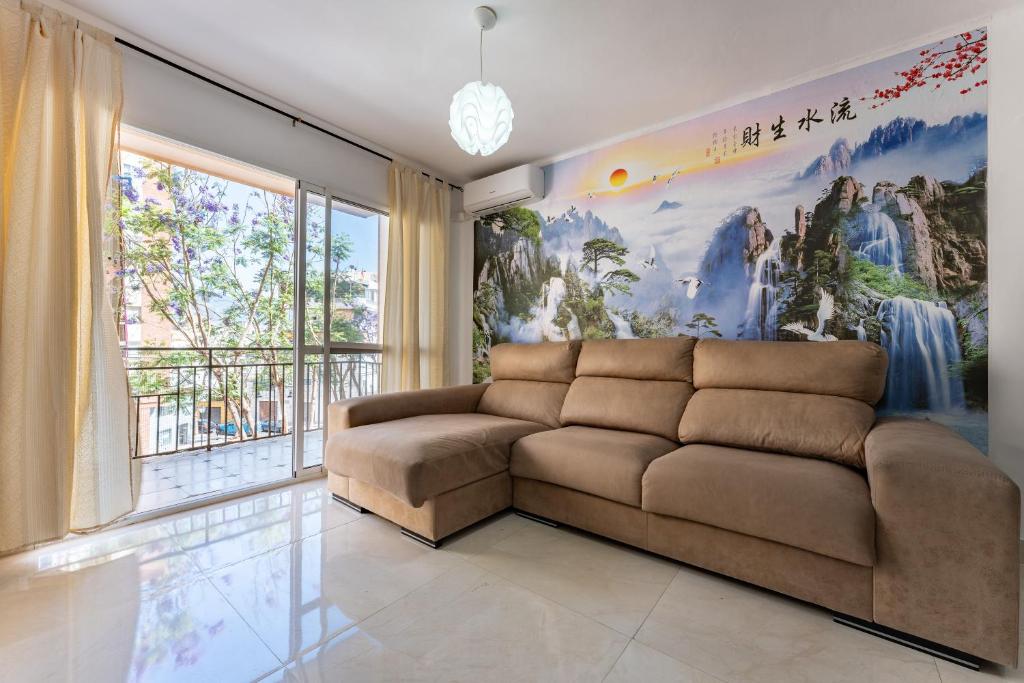 a living room with a couch and a large painting at Casa de Bella Fuengirola in Fuengirola