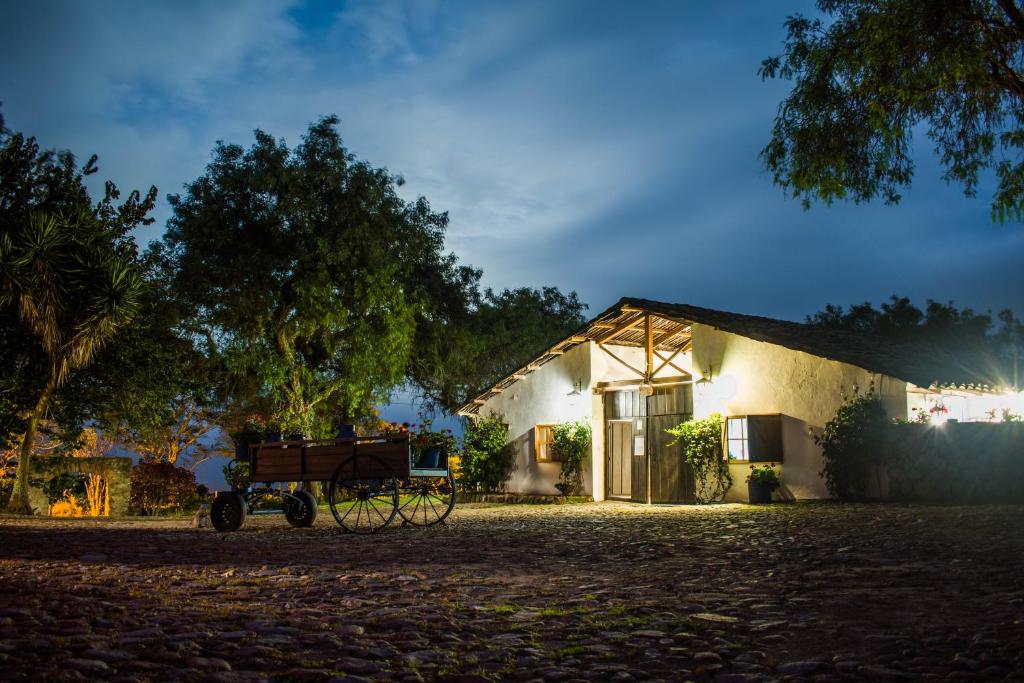a horse drawn carriage parked in front of a house at Hacienda San Francisco in Tumbabiro