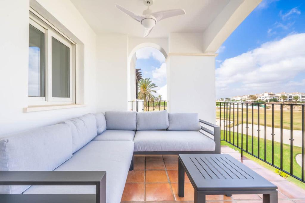 a living room with a couch and a balcony at Stunning apartment at La Torre Golf Resort MO6022L in Roldán
