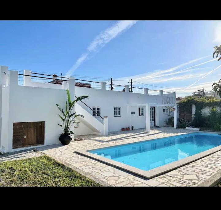 a house with a swimming pool in front of it at Quinta Felicidade - Sea&Surf in Óbidos