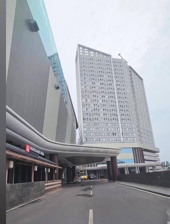a large building with a parking lot in front of it at Apartment The Bay AisBeLL in Kuala