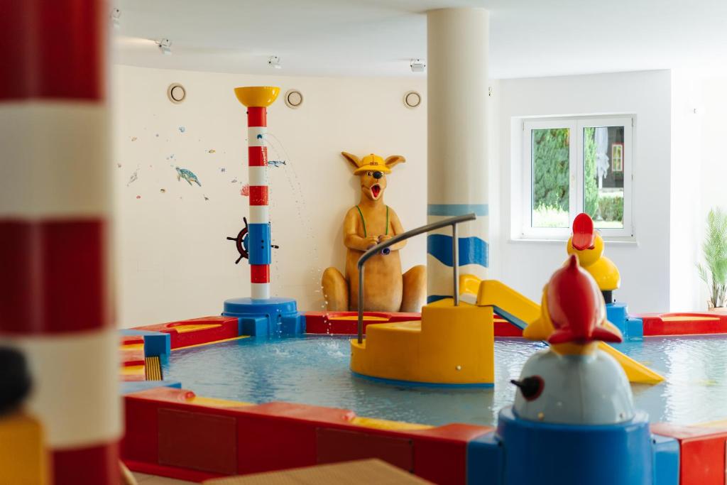 a childs play room with a water park with toys at Familienhotel Trebesingerhof in Trebesing