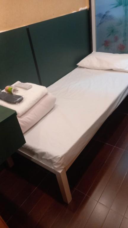 A bed or beds in a room at New Garden Hostel