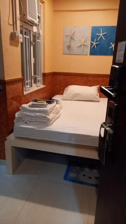 A bed or beds in a room at New Garden Hostel