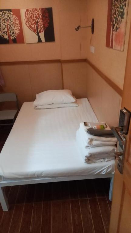 A bed or beds in a room at New Garden Hostel