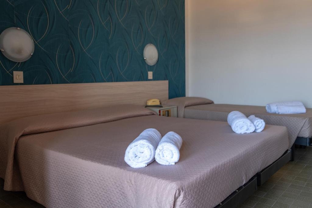 Postel nebo postele na pokoji v ubytování Hotel Re Leone